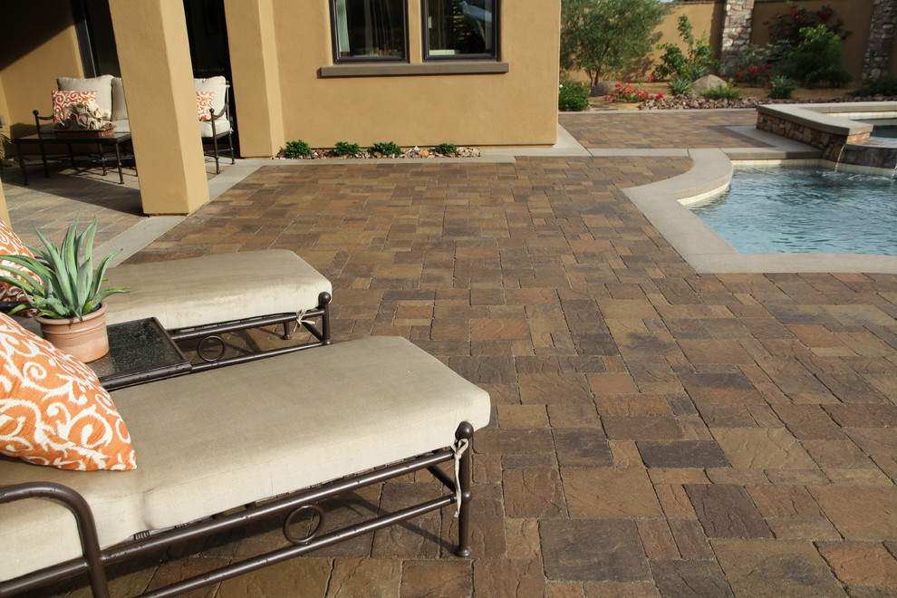 Inspiration for a mid-sized backyard concrete paver pool house remodel in Orange County