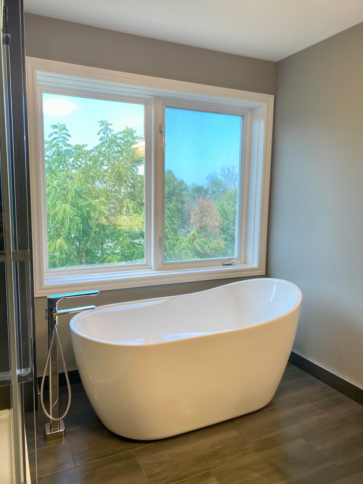 Inspiration for a huge transitional master porcelain tile porcelain tile, gray floor and single-sink freestanding bathtub remodel with recessed-panel cabinets, a one-piece toilet, an undermount sink, quartzite countertops, white countertops and a built-in vanity