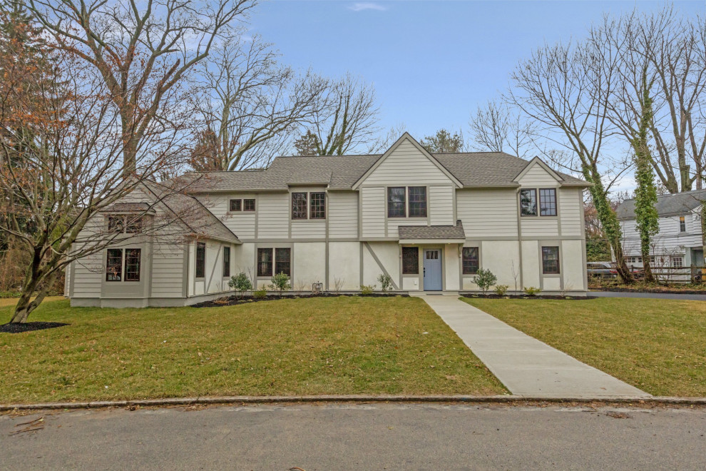 Large contemporary two-storey beige house exterior in Philadelphia with mixed siding and a shingle roof.
