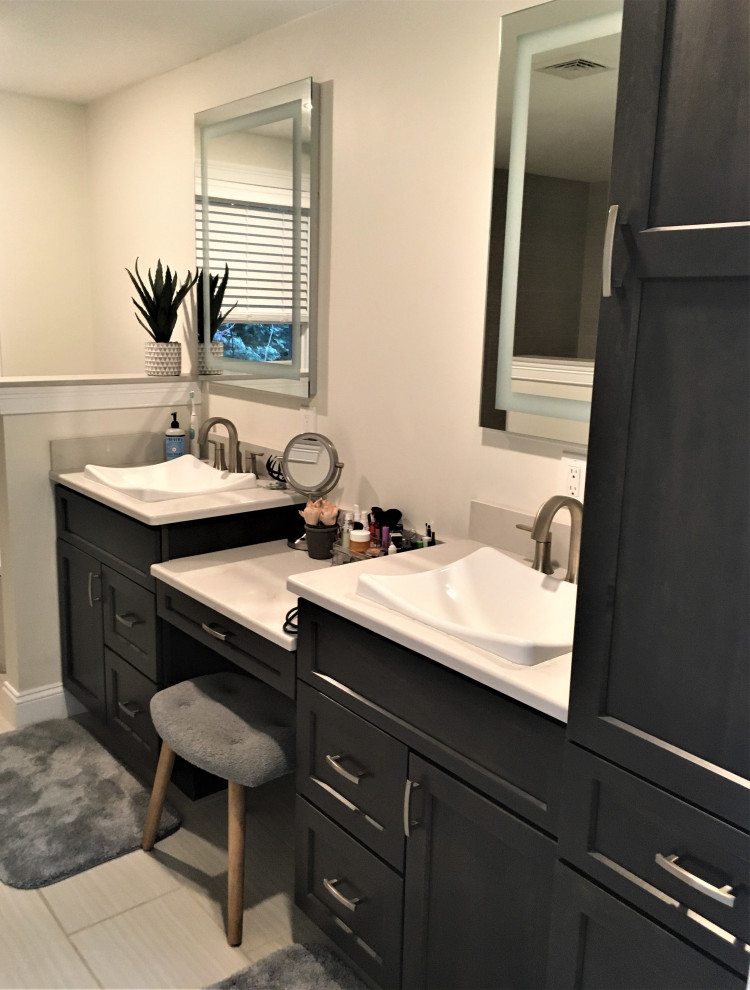 Transitional master bathroom in Boston with shaker cabinets, dark wood cabinets, an open shower, a one-piece toilet, beige tile, ceramic tile, beige walls, ceramic floors, a vessel sink, engineered quartz benchtops, beige floor, an open shower, white benchtops, a shower seat, a double vanity and a built-in vanity.