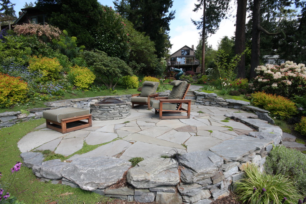 Design ideas for a contemporary patio in Seattle with a fire feature and natural stone pavers.