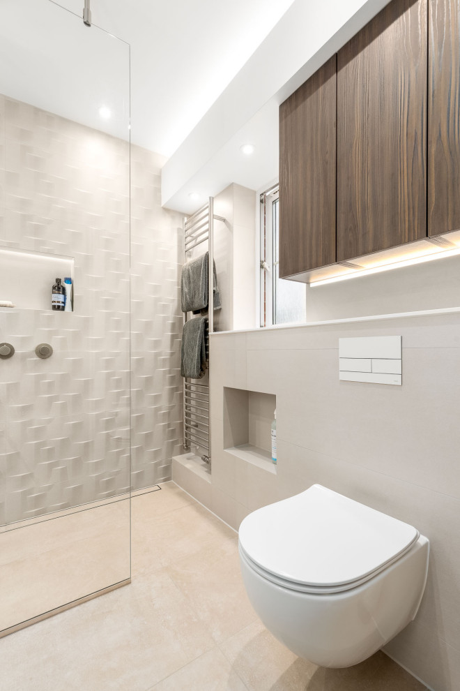 Design ideas for a medium sized contemporary ensuite bathroom in Berkshire with flat-panel cabinets, brown cabinets, a walk-in shower, a wall mounted toilet, beige tiles, ceramic tiles, beige walls, porcelain flooring, a built-in sink, solid surface worktops, beige floors, an open shower, white worktops, a feature wall, a single sink and a floating vanity unit.
