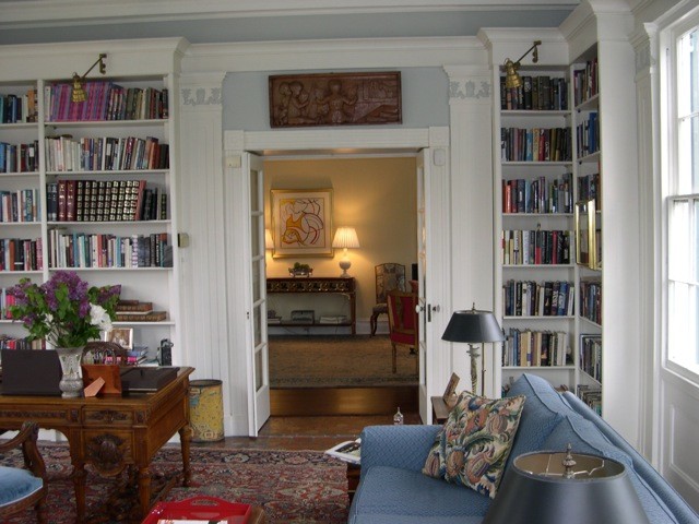 This is an example of a large traditional study room in New York with carpet, no fireplace, a freestanding desk, grey walls and brown floor.