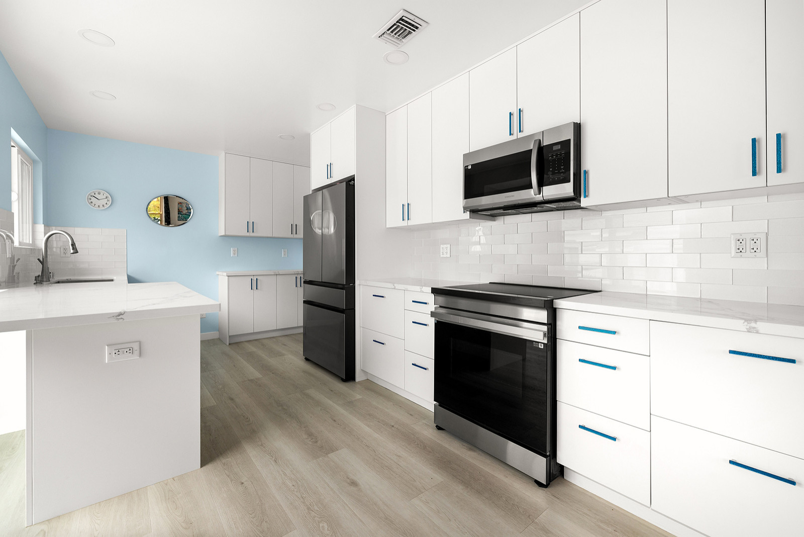 Appliances, Cabinetry, Tile Backsplash, and Plank Vinyl Laminate Flooring