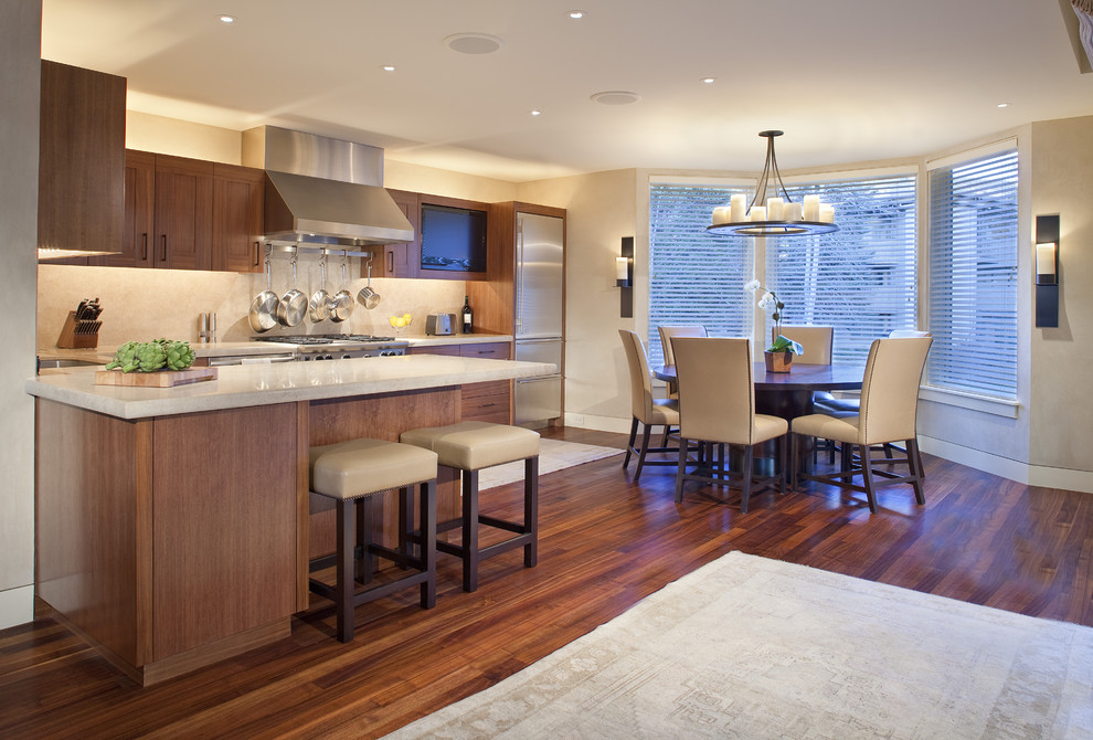 Photo of a contemporary l-shaped eat-in kitchen in Denver with stainless steel appliances and dark wood cabinets.