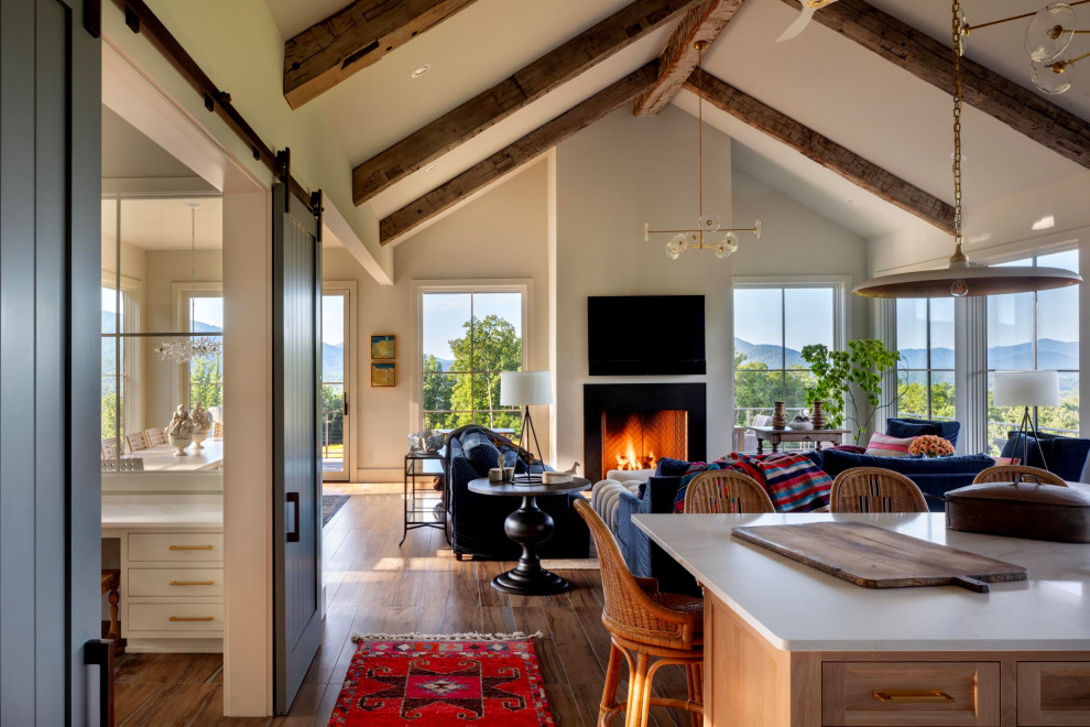 Living room - huge transitional open concept porcelain tile, brown floor and exposed beam living room idea in Richmond with beige walls, a standard fireplace, a tile fireplace and a wall-mounted tv