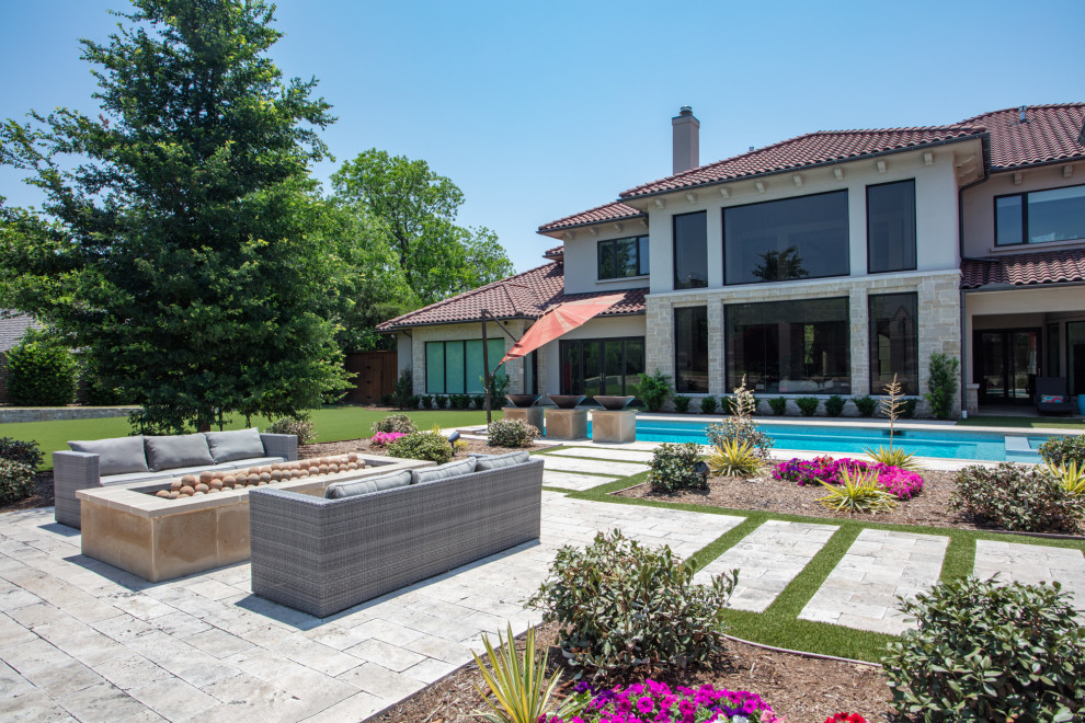 This is an example of a large contemporary backyard garden in Dallas.