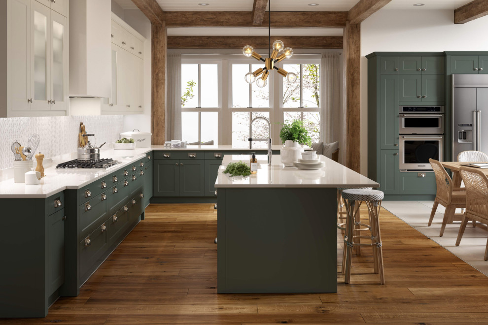 Example of a classic open concept kitchen design in Other with an integrated sink, shaker cabinets, green cabinets, quartzite countertops, stainless steel appliances, an island and white countertops