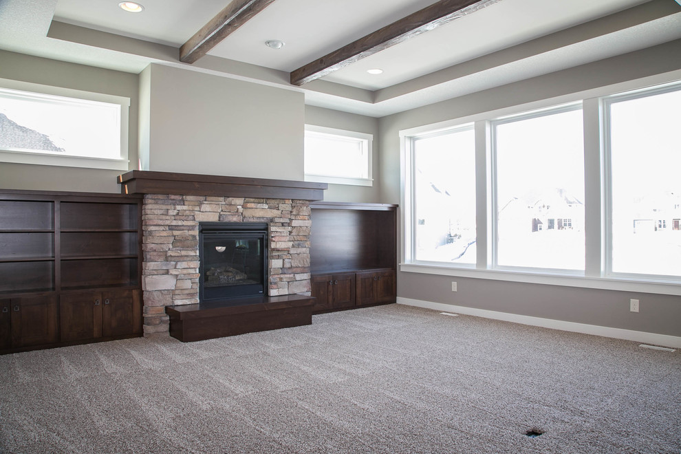 Country open concept living room in Minneapolis with grey walls, carpet, a standard fireplace, a stone fireplace surround and a built-in media wall.