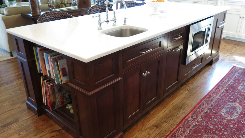 Transitional home design photo with white cabinets, quartz countertops and white backsplash