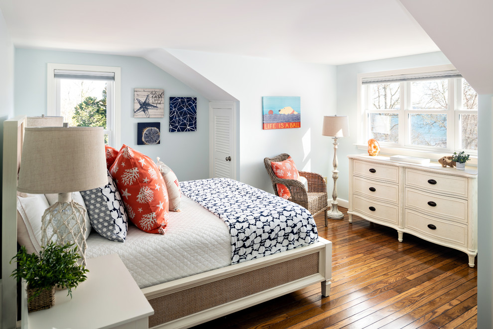 This is an example of a beach style bedroom in Boston with blue walls, dark hardwood floors and brown floor.