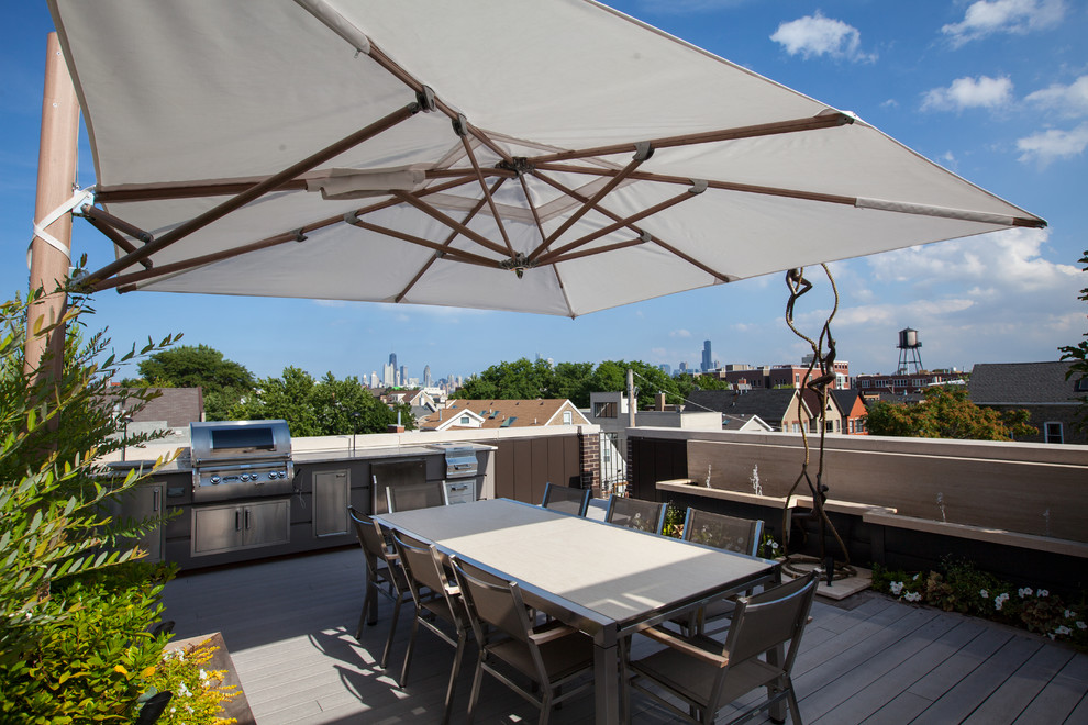 Mid-sized contemporary rooftop deck in Chicago with a water feature and an awning.