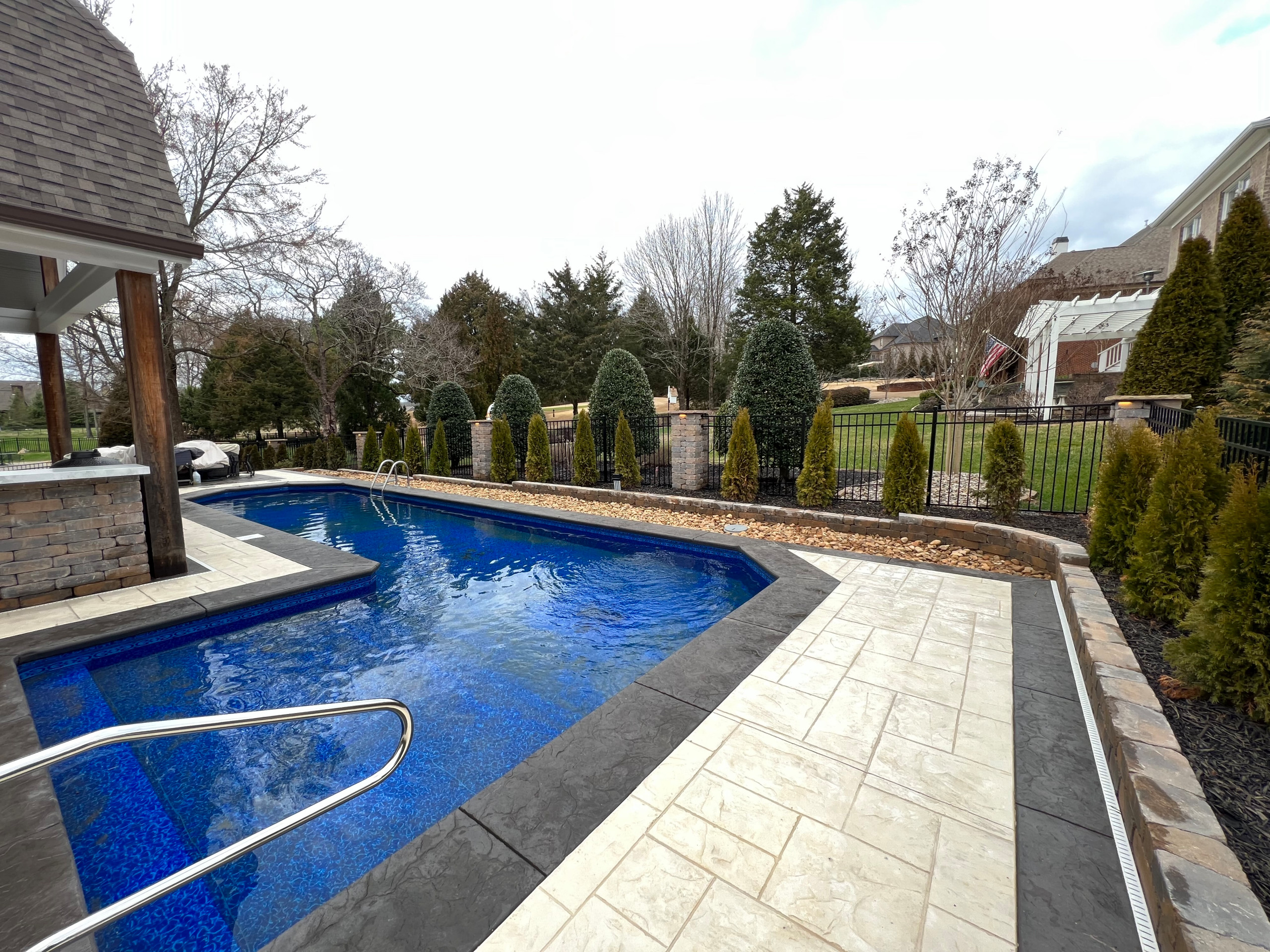 Outdoor kitchen/ fireplace and pool landscaping