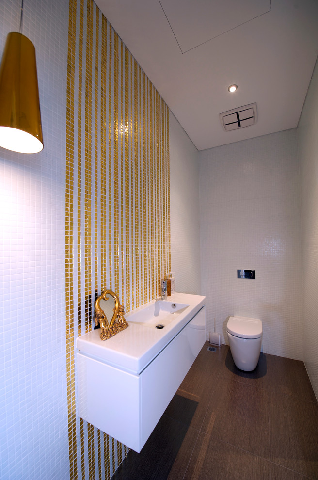 Photo of a small contemporary powder room in Sydney with porcelain tile, porcelain floors, a one-piece toilet, multi-coloured tile, multi-coloured walls and an integrated sink.