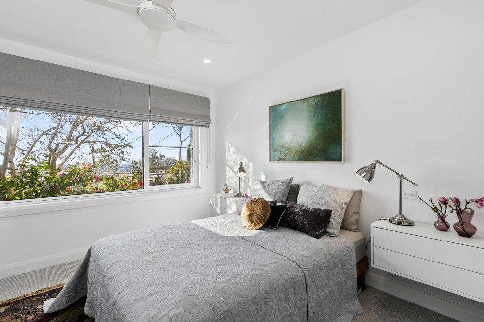 Mid-sized transitional master bedroom in Geelong with carpet and grey floor.