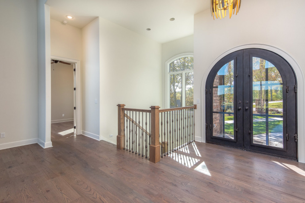 Inspiration for a large transitional dark wood floor and brown floor front door remodel with white walls and a glass front door