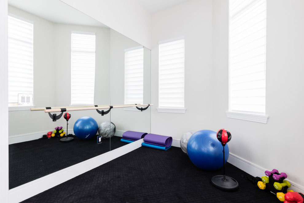 This is an example of a small contemporary multipurpose gym in Orlando with white walls, carpet and black floor.