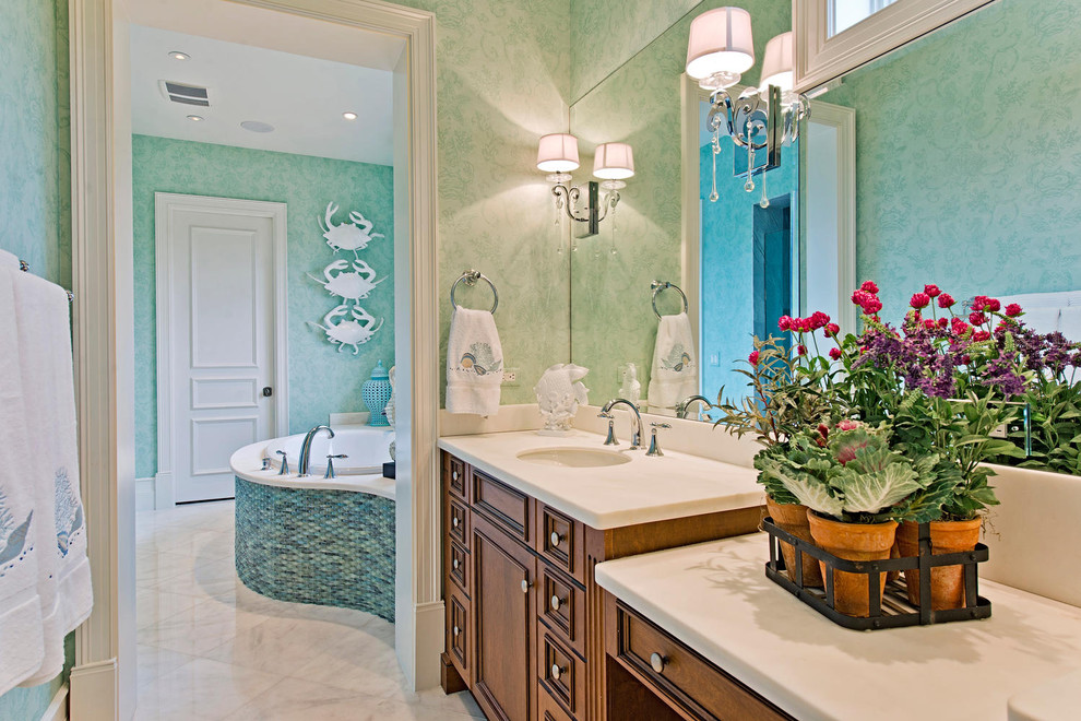 This is an example of a tropical bathroom in Miami with shaker cabinets and white benchtops.