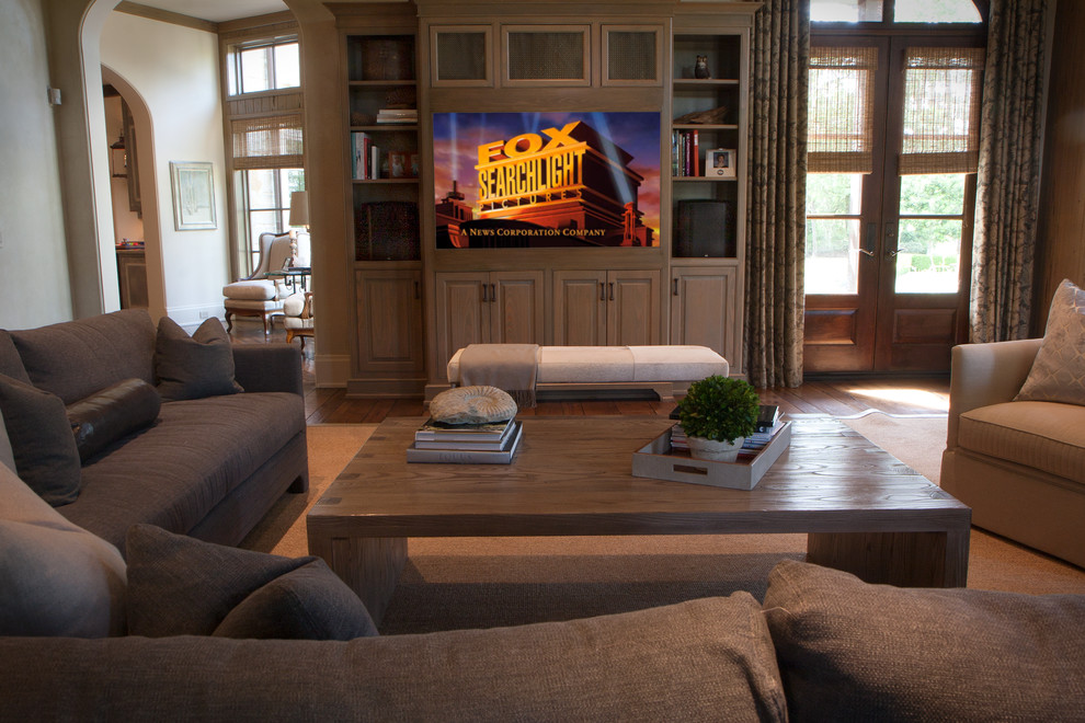 Photo of a traditional family room in Houston with beige walls, dark hardwood floors and a built-in media wall.