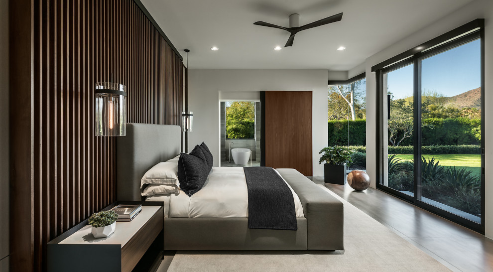 Design ideas for an expansive contemporary master bedroom in Phoenix with white walls.