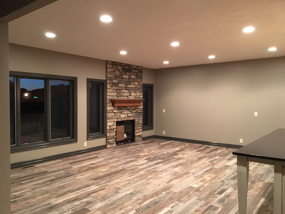 Inspiration for a mid-sized transitional open concept living room in Omaha with beige walls, porcelain floors, a standard fireplace, a stone fireplace surround, no tv and multi-coloured floor.