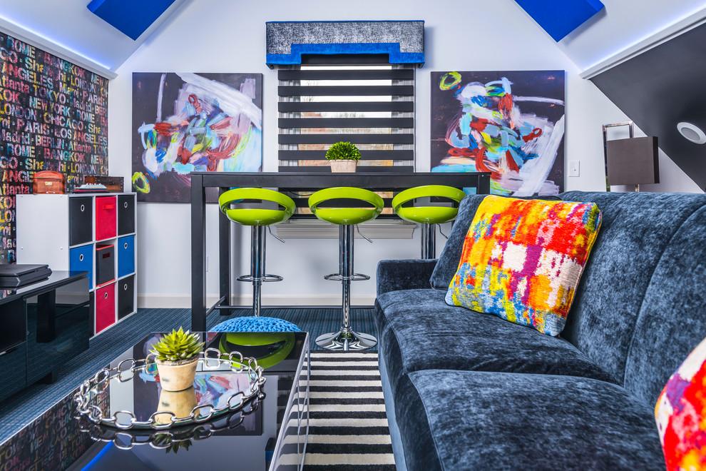 Coming of Age - a teen 'hang space' - Lime green bar stools, at the USB charging port table, immediately catch your eye as you enter the room. The black walls expand the space in this bonus room, while the white walls provide high contrast and the ability to reflect back whatever color the LED lights are displaying. Photography: Reed Brown Design: Chantae Thompson and Bohnne Jones