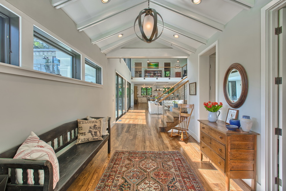 Hallway - huge traditional light wood floor hallway idea in Los Angeles with gray walls