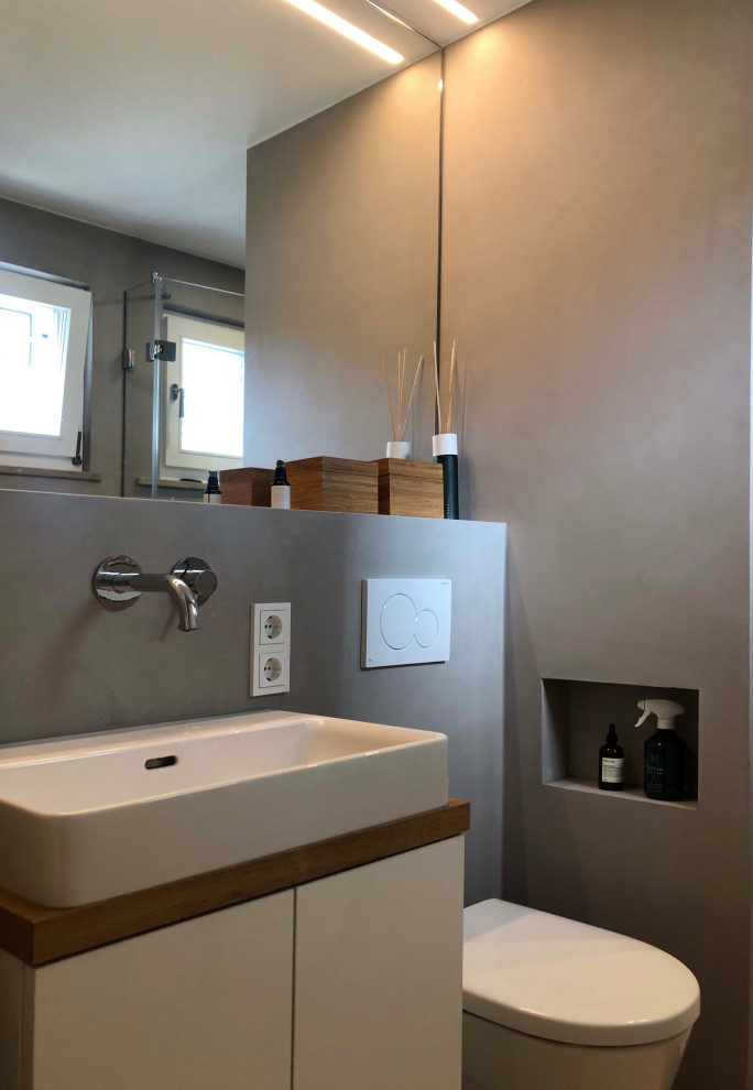 Inspiration for a small contemporary shower room bathroom in Munich with flat-panel cabinets, white cabinets, a walk-in shower, a wall mounted toilet, beige walls, mosaic tile flooring, a vessel sink, pink floors, an open shower, white worktops, a single sink and a built in vanity unit.