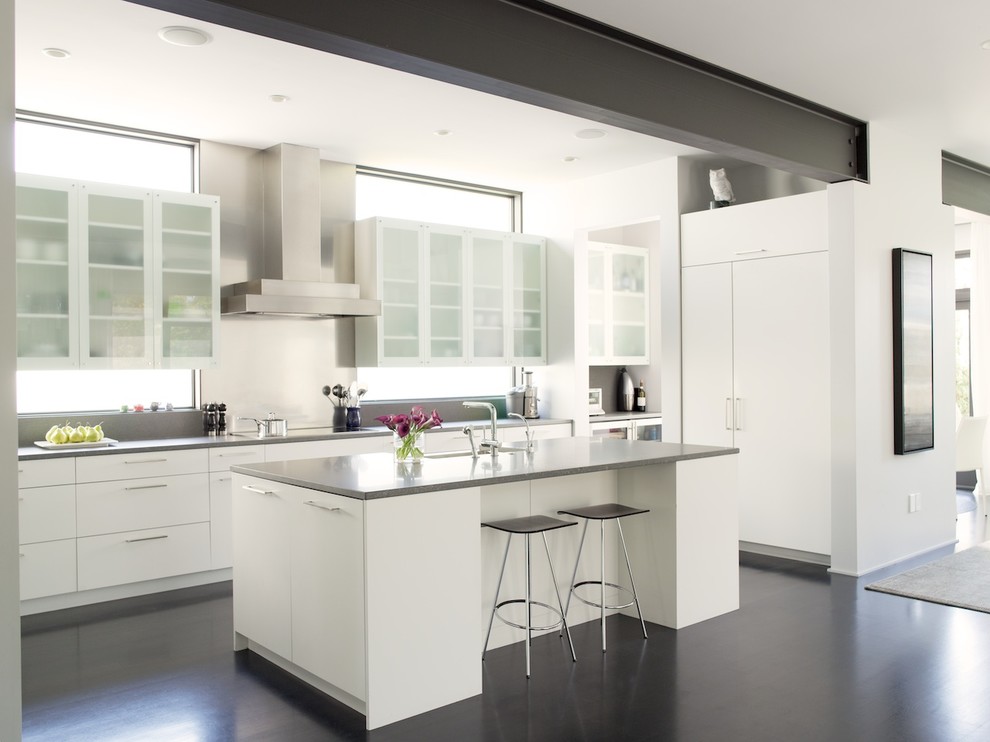 Large contemporary open plan kitchen in Seattle with glass-front cabinets, white cabinets, panelled appliances, dark hardwood floors and with island.