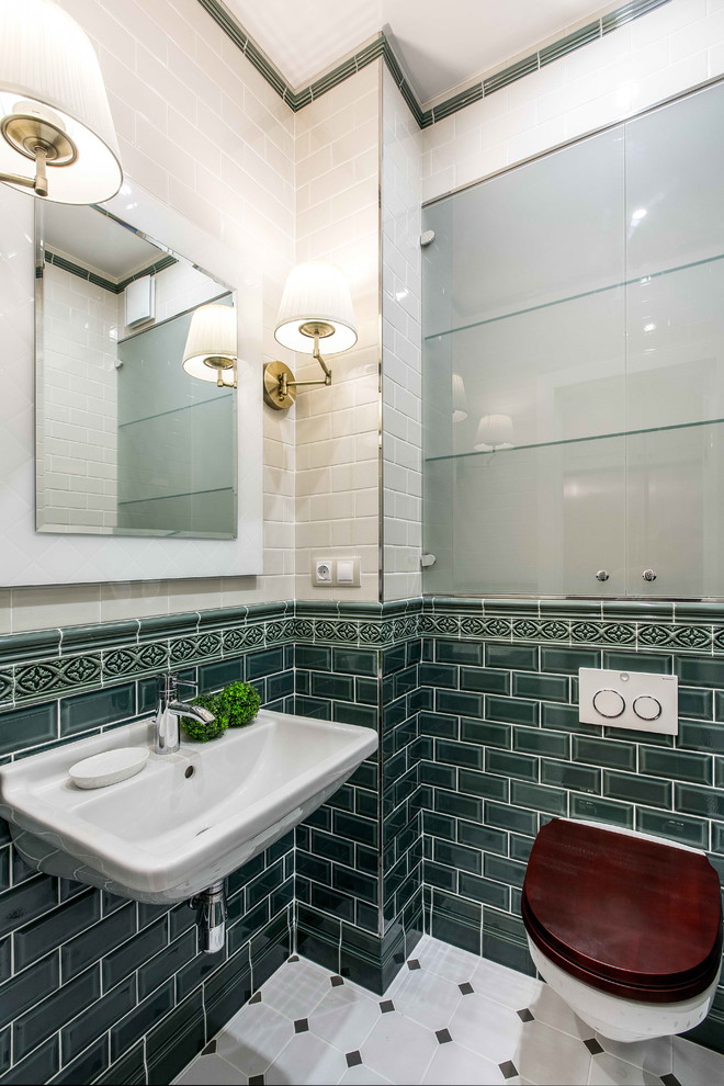 This is an example of a transitional powder room in Other with glass-front cabinets, a wall-mount toilet, green tile, white tile, a wall-mount sink and white floor.