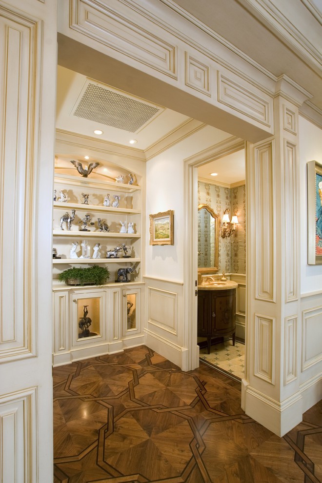This is an example of a traditional hallway in Orange County with white walls and dark hardwood floors.