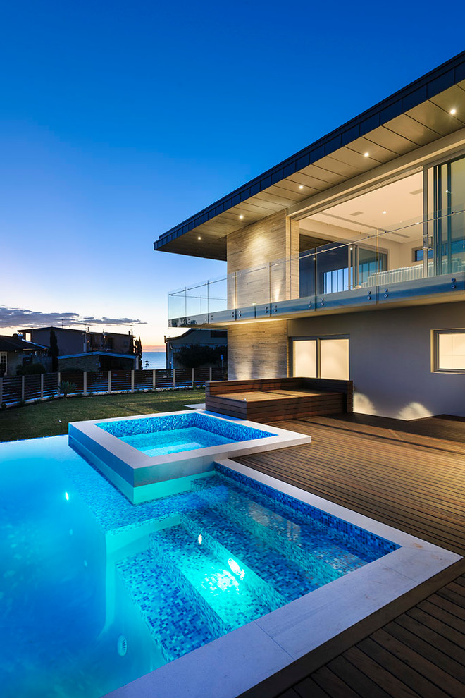 Inspiration for a contemporary custom-shaped infinity pool in Perth with a hot tub.