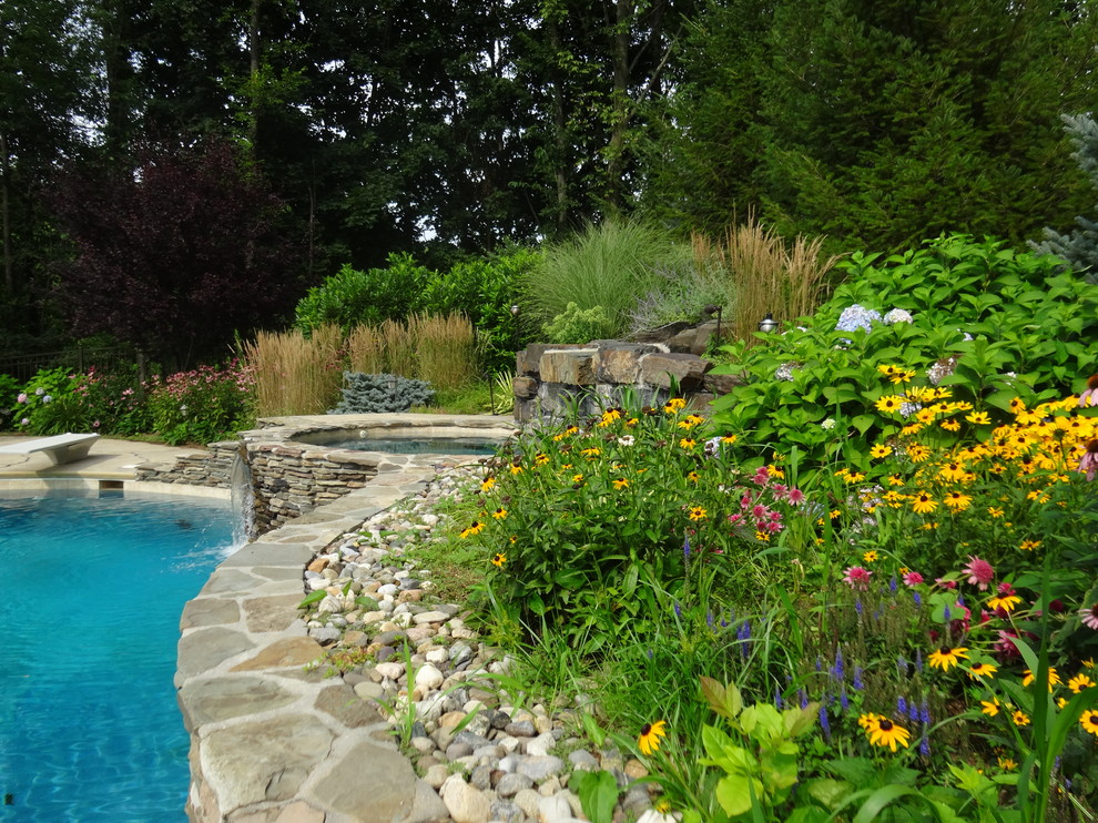 Design ideas for a large traditional backyard garden in New York with a water feature and natural stone pavers.