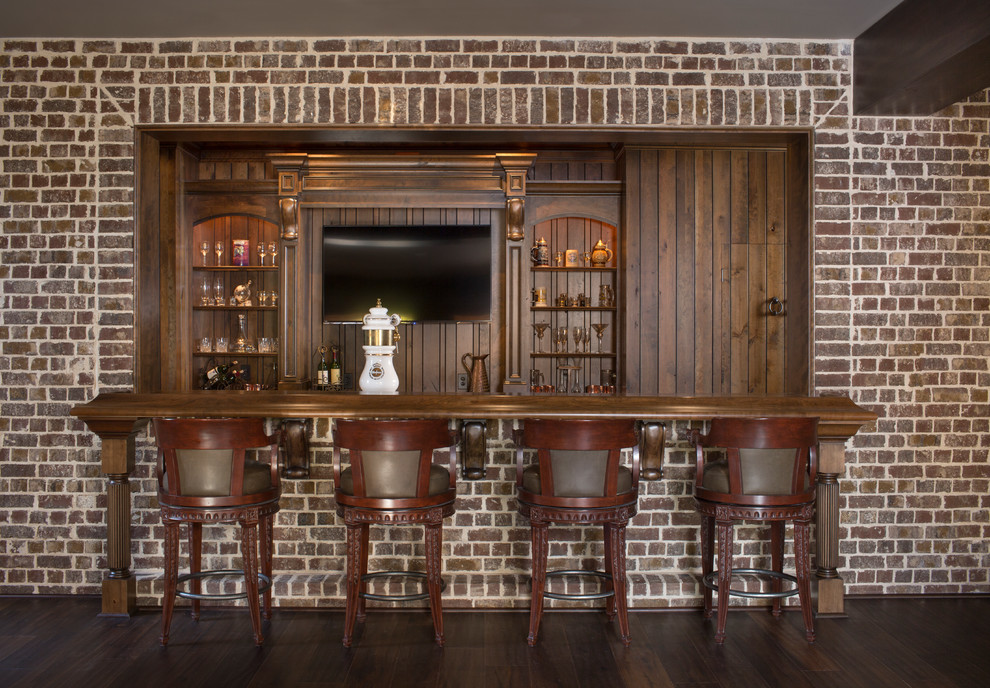 This is an example of a mid-sized galley seated home bar in Atlanta with an undermount sink, beaded inset cabinets, dark wood cabinets, marble benchtops, brown splashback and marble floors.