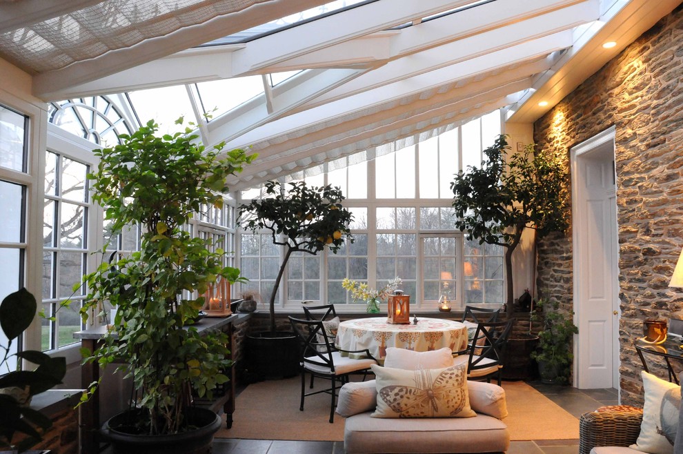 Large traditional sunroom in Philadelphia with a glass ceiling and slate floors.