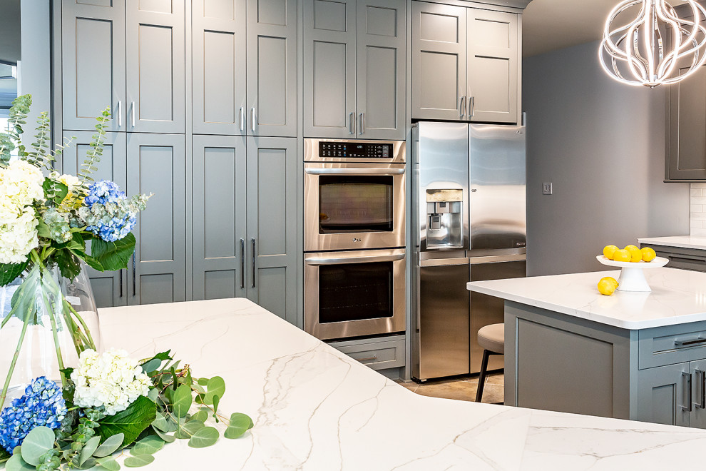 Inspiration for a large transitional u-shaped ceramic tile and gray floor eat-in kitchen remodel in Richmond with an undermount sink, gray cabinets, granite countertops, red backsplash, ceramic backsplash, stainless steel appliances, an island and white countertops