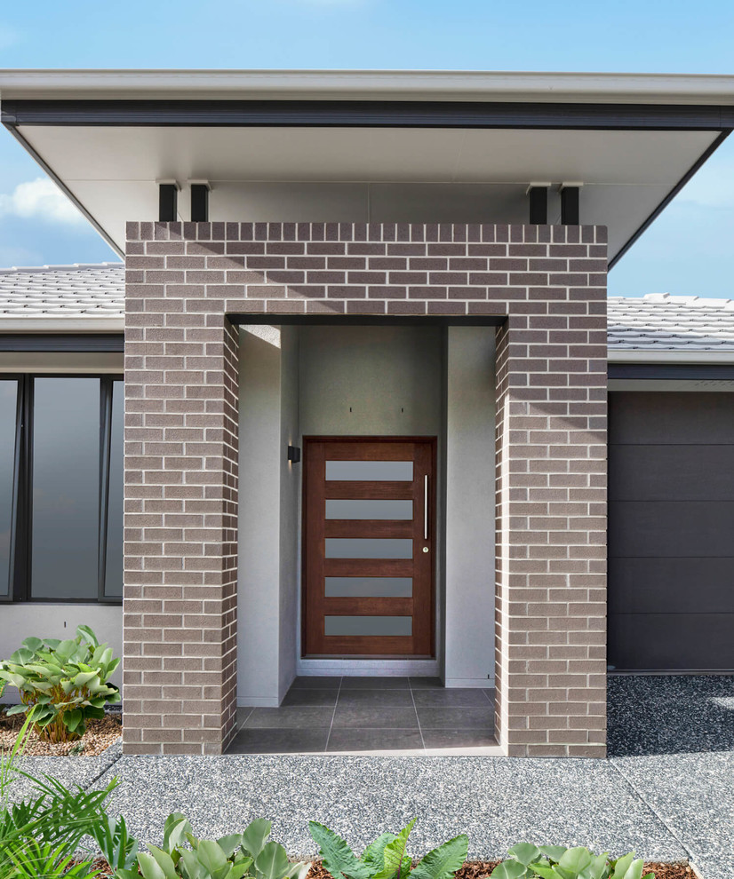 Inspiration for a modern front door in Gold Coast - Tweed with a single front door and a dark wood front door.