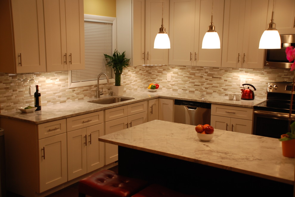 Inspiration for a mid-sized transitional l-shaped eat-in kitchen remodel in DC Metro with shaker cabinets, white cabinets, beige backsplash, stainless steel appliances and an island