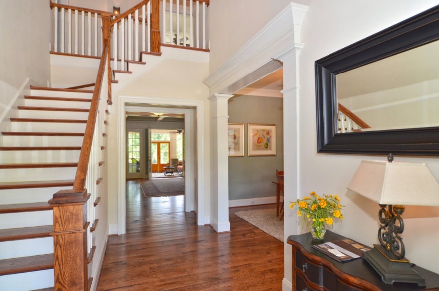 Inspiration for a medium tone wood floor entryway remodel with white walls
