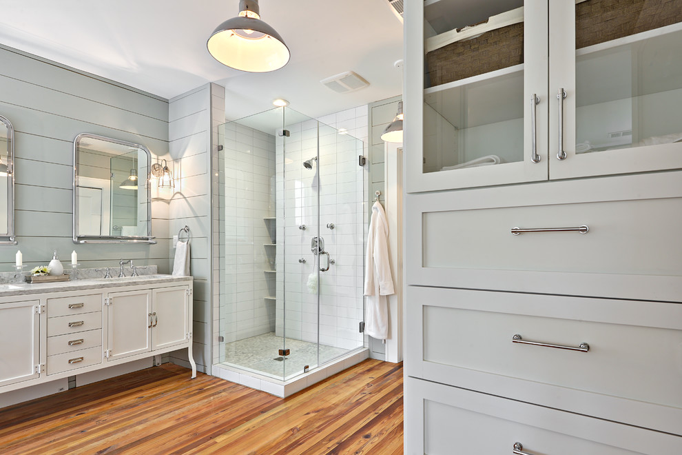 Design ideas for a large transitional master bathroom in Austin with marble benchtops, a claw-foot tub, a corner shower, blue walls, medium hardwood floors, shaker cabinets and white cabinets.
