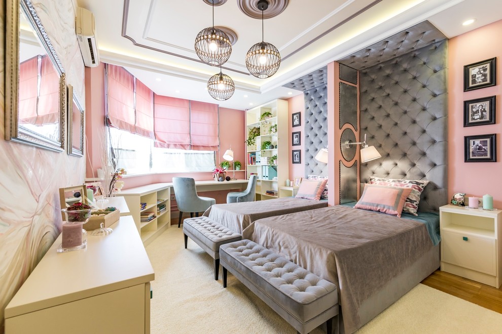 Photo of a transitional kids' bedroom for girls in Moscow with pink walls, medium hardwood floors and brown floor.