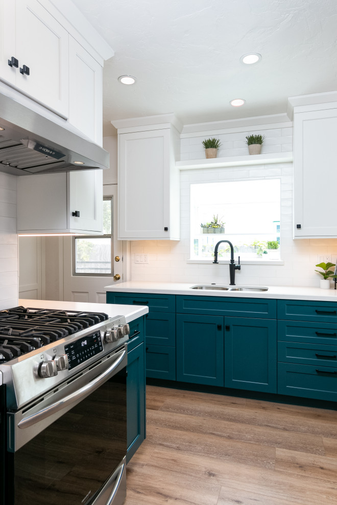 Design ideas for a small transitional l-shaped separate kitchen in Los Angeles with an undermount sink, shaker cabinets, blue cabinets, quartz benchtops, multi-coloured splashback, ceramic splashback, stainless steel appliances, vinyl floors, no island, brown floor and white benchtop.