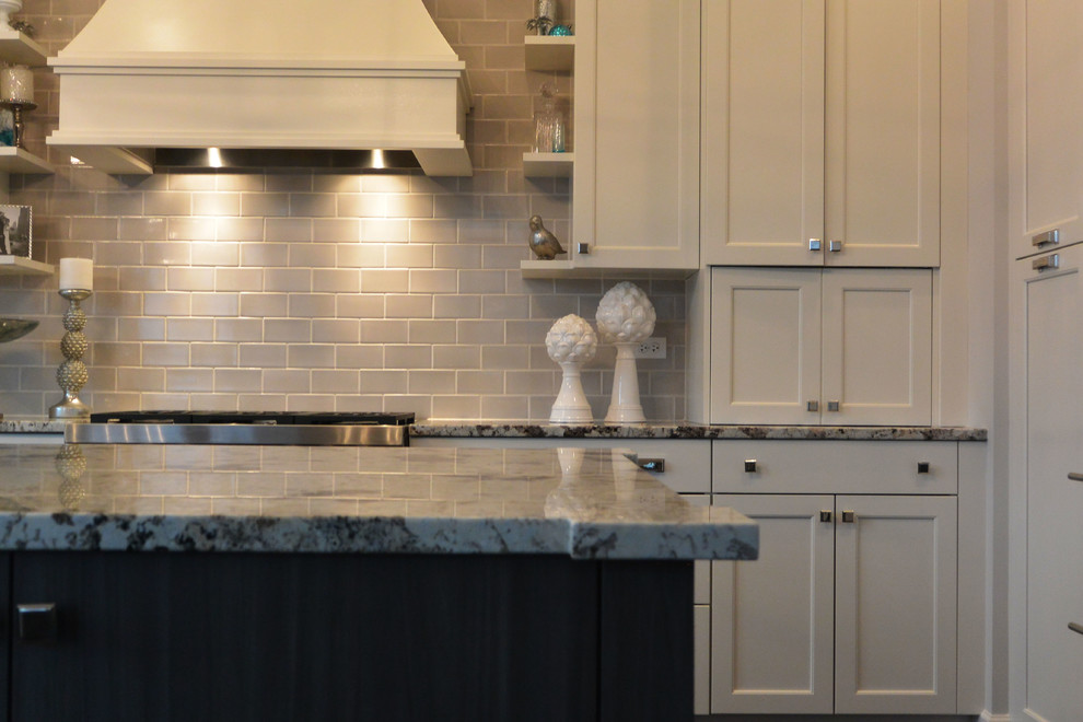 Transitional l-shaped eat-in kitchen photo in Chicago with a single-bowl sink, recessed-panel cabinets, white cabinets, quartzite countertops, gray backsplash, subway tile backsplash and stainless steel appliances