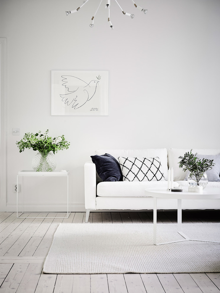 Inspiration for a mid-sized scandinavian formal living room in Gothenburg with white walls, light hardwood floors and no tv.