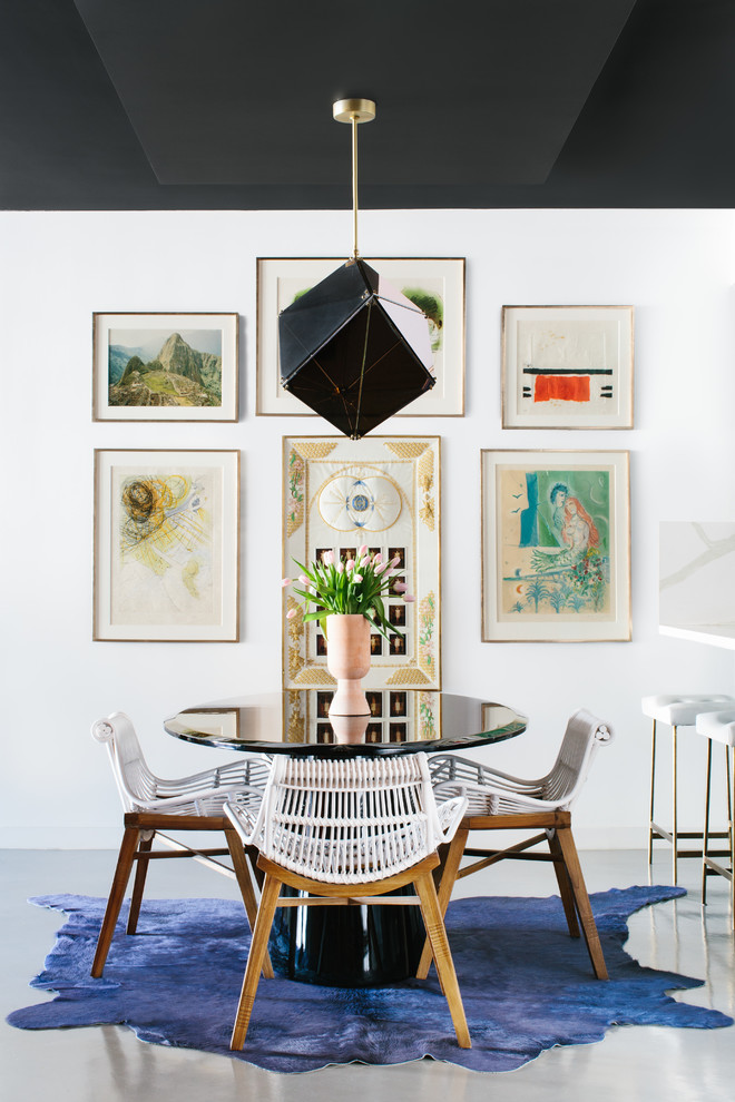 Inspiration for a small contemporary dining room in Los Angeles with white walls and grey floor.