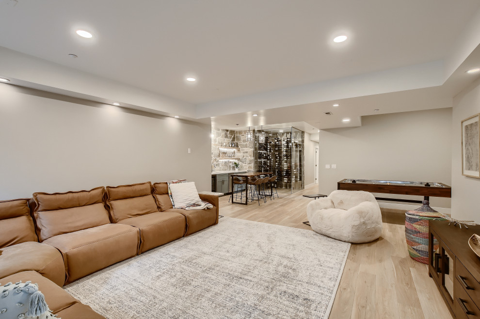 Inspiration for a large mediterranean look-out basement in Denver with grey walls, laminate floors and grey floors.