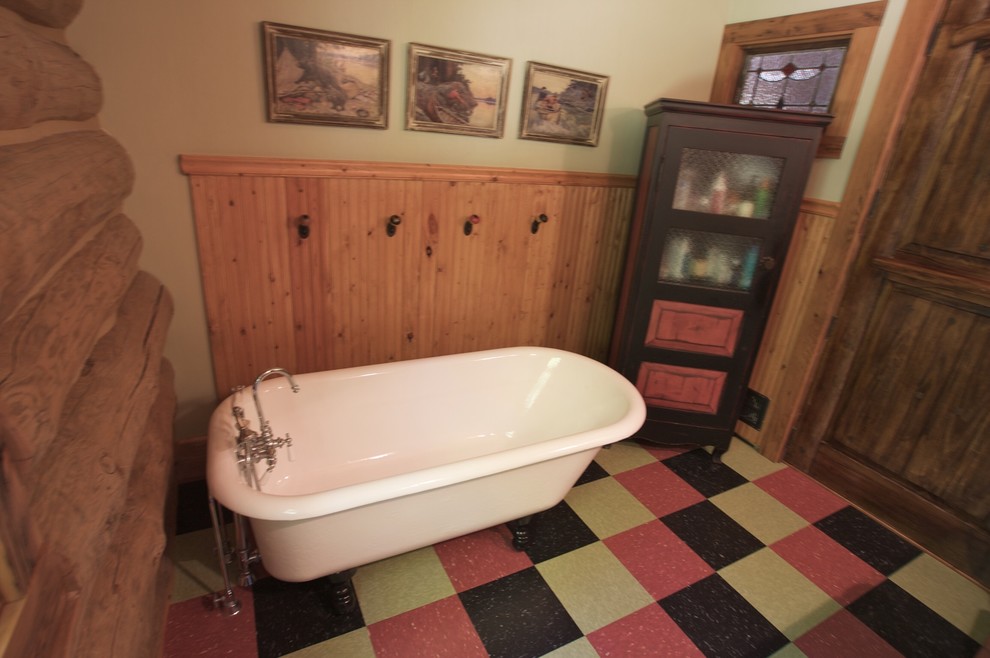 Example of a large mountain style 3/4 linoleum floor freestanding bathtub design with recessed-panel cabinets, beige walls, a vessel sink and solid surface countertops