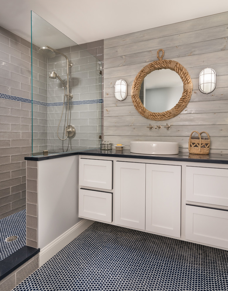Beach style 3/4 bathroom in Providence with shaker cabinets, white cabinets, an alcove shower, gray tile, subway tile, grey walls, mosaic tile floors, a vessel sink, blue floor, an open shower and black benchtops.