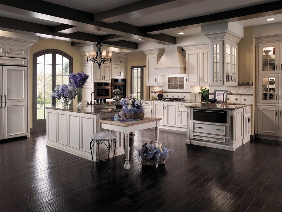 Inspiration for a large transitional l-shaped dark wood floor and brown floor kitchen remodel in DC Metro with an undermount sink, recessed-panel cabinets, white cabinets, granite countertops, paneled appliances, an island and multicolored countertops