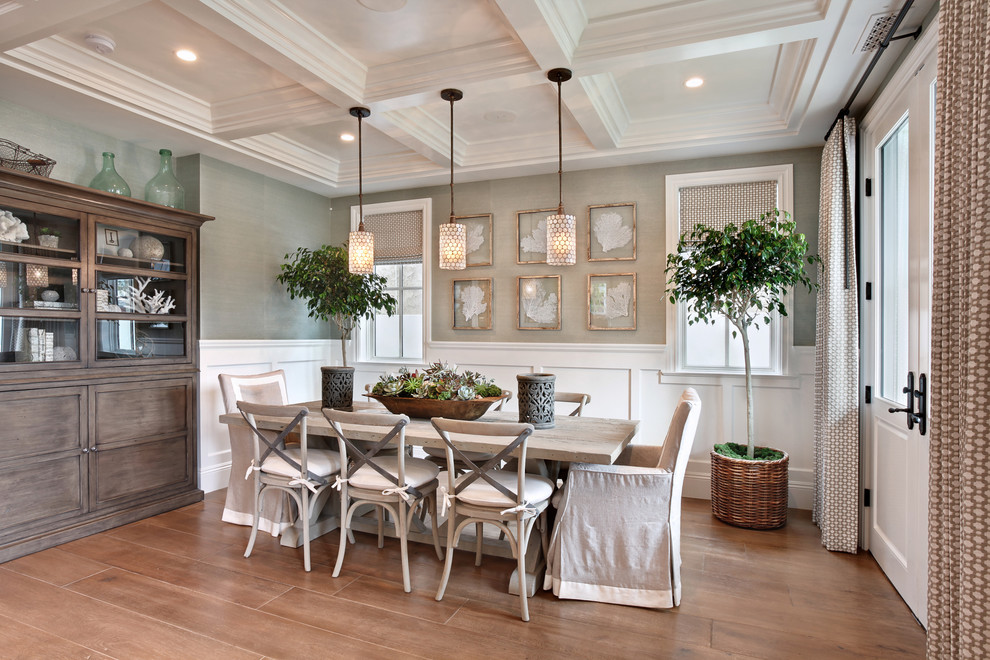 Design ideas for a beach style dining room in Orange County with grey walls, medium hardwood floors and beige floor.